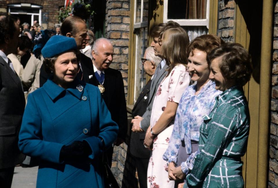 The Queen visits the recently rebuilt set of ITV’s Coronation Street in May 1982 and meets some of the cast; from left to right: Jack Howarth, William Roache, Anne Kirkbride, Eileen Derbyshire and Thelma Barlow (PA) (PA Archive)
