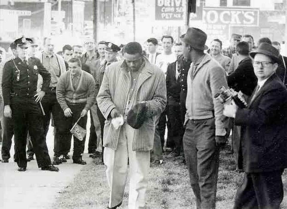 This photo from the Feb. 13, 1960, Evening Herald shows Bunt Gill wiping egg from his hat as police officers stand guard on West Main Street in Rock Hill. Elwin Wilson, now 72, is pictured in a white jersey over Gill’s left shoulder. Wilson, who said he threw the egg, apologized to black protesters of segregation Friday at Old Town Bistro on East Main Street in Rock Hill.