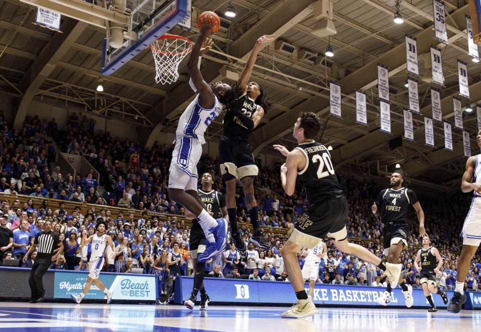 Duke's Mark Mitchell, front left, jumps to shoot ahead of Wake Forest's Hunter Sallis (23), Parker Friedrichsen (20), and Efton Reid III (4) during the second half of an NCAA college basketball game in Durham, N.C., Monday, Feb. 12, 2024. (AP Photo/Ben McKeown)