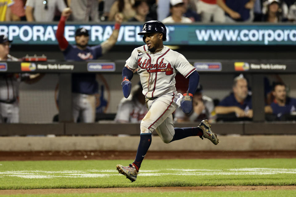 Atlanta Braves' Ozzie Albies runs home to score during the eighth inning in the second baseball game of a doubleheader on Saturday, Aug. 12, 2023, in New York. (AP Photo/Adam Hunger)