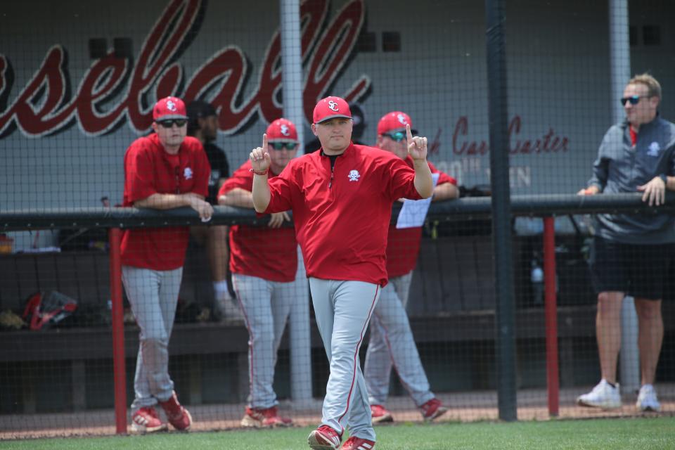 Savannah Christian coach Matt Oglesby gives signs to a baserunner during the GHSA Class A Private quarterfinal game against Fellowship Christian on Wednesday. Visiting Fellowship Christian won 6-0 to claim the best-of-three series.