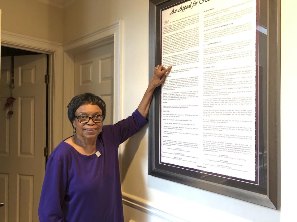 FILE - In this March 4, 2020 photo, Roslyn Pope poses with a framed copy of "An Appeal for Human Rights" in her home in Atlanta. Roslyn Pope, a college professor and musician who wrote “An Appeal for Human Rights,” laying out the reasons for the Atlanta Student Movement against systemic racism in 1960, has died. She was 84. Pope died on Jan. 18 in Arlington, Texas, where she moved from Atlanta to be with her daughters after her health began to fail in 2021, according to her family's obituary. (AP Photo/Michael Warren, file)