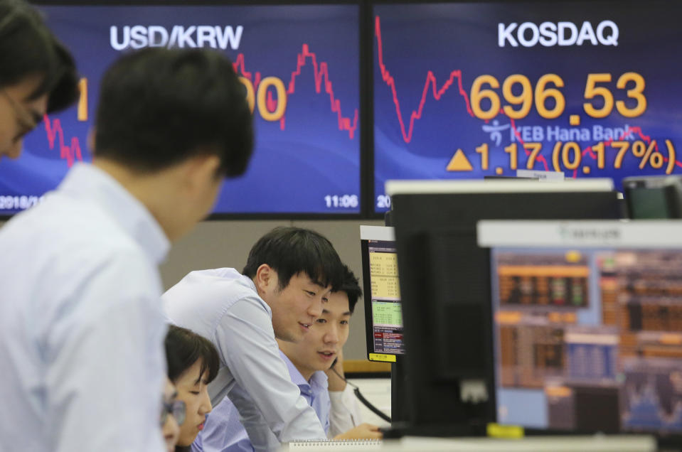 Currency traders watch monitors at the foreign exchange dealing room of the KEB Hana Bank headquarters in Seoul, South Korea, Tuesday, Nov. 27, 2018. Asian markets clocked more gains Tuesday ahead of a meeting between the U.S. and China at the Group of 20 summit this week, despite President Donald Trump's comments that it's "highly unlikely" he'll hold off on raising tariffs as Beijing requested. (AP Photo/Ahn Young-joon)