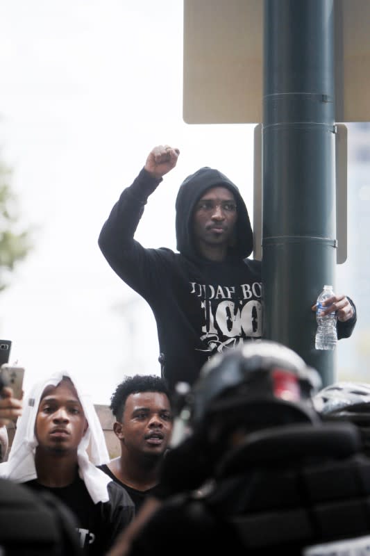 <p>Protestors face police near the Bank of America during the game between the Minnesota Vikings and the Carolina Panthers. Mandatory Credit: Angela Wilhelm/Citizen-Times via USA TODAY NETWORK </p>