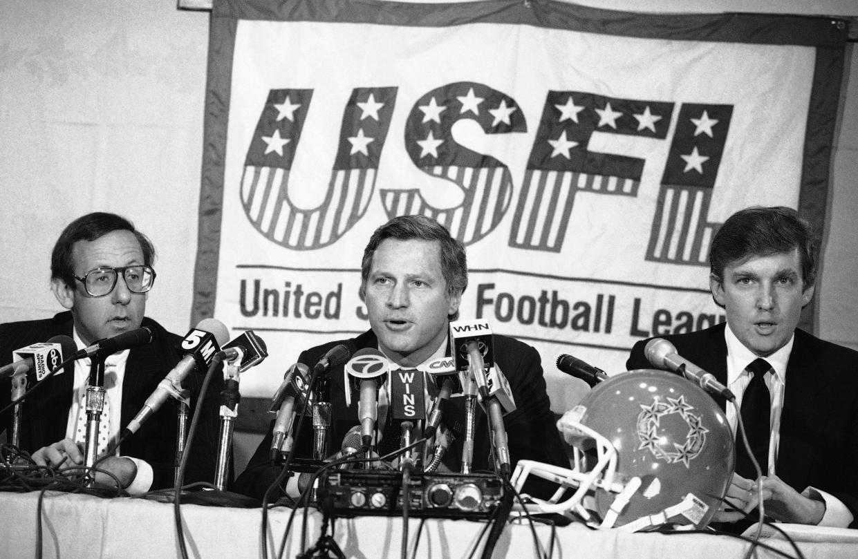 New York real estate magnates Stephen Ross, left, and Donald Trump, right, speak about the agreement they have reached in principle to merge the Houston Gamblers and New Jersey Generals football franchises, Thursday, August 2, 1985 in New York. USFL Commissioner Harry L. Usher, center announced the agreement.