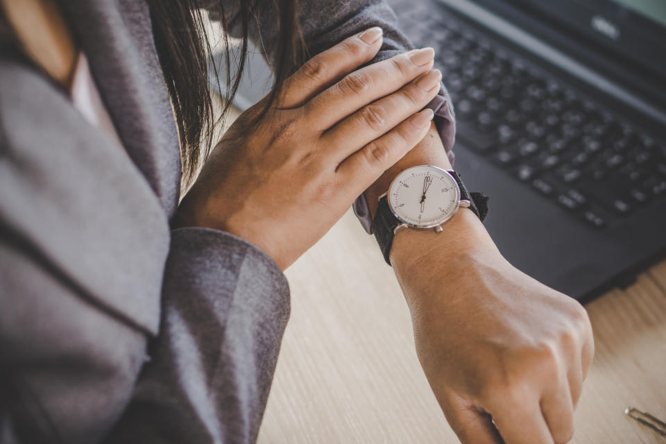 Man looks at watch, running late because of sex