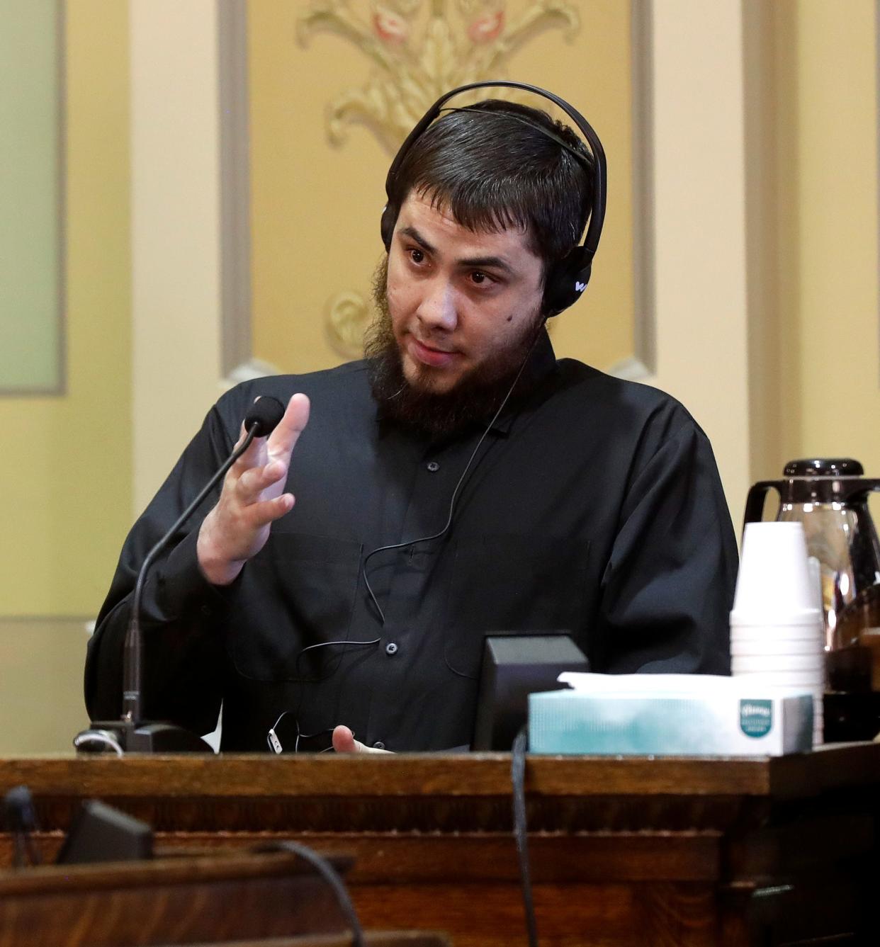 Jeisaac Rodriguez-Garcia testifies on Feb. 28, 2023, during a jury trial for Pedro Santiago-Marquez, who is charged with first-degree intentional homicide and mutilating a corpse, both as party to a crime, in Green Bay, Wis. Rodriguez-Garcia also has been charged with mutilating a corpse in connection to the incident.