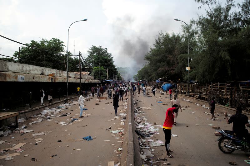 Smoke rises supporters of Imam Mahmoud Dicko and other opposition political parties protest against President Ibrahim Boubacar Keita in Bamako