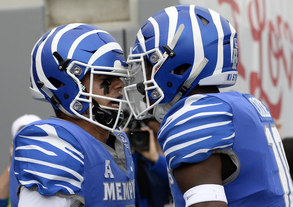 Memphis quarterback Brady White, left, celebrates with wide receiver Damonte Coxie (10) after Brady scored a touchdown on a 11-yard run against Central Florida during the first half of an NCAA college football game Saturday, Oct. 13, 2018, in Memphis, Tenn. (AP Photo/Mark Zaleski)