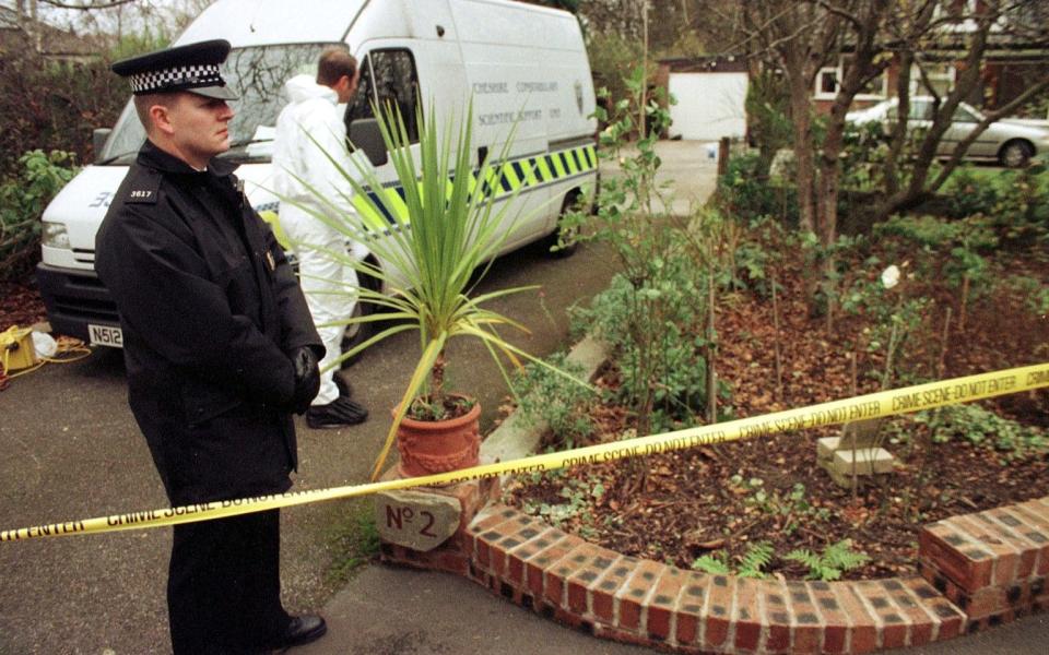 Police outside the property where the Wards were killed in 1999 - PA
