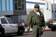 A member of the Los Angeles County Sheriff dept. stands outside of Saugus High School with his weapon drawn after reports of a shooting on Thursday, Nov. 14, 2019, in Santa Clarita, Calif. (AP Photo/Marcio Jose Sanchez)