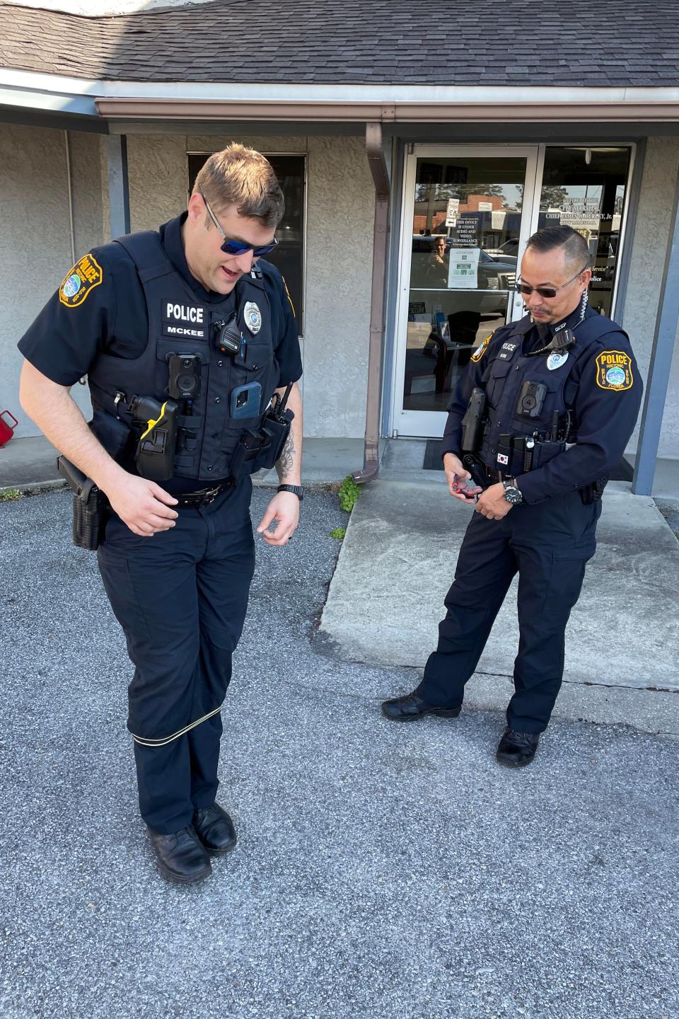 DeFuniak Springs Police Officer Josh McKee (left) tries to walk after having the BolaWrap restraint system demonstrated on him by Field Training Officer Wan Boros. The BolaWrap shoots a small cord that wraps around the legs or arms to restrain a person without causing serious  injury.