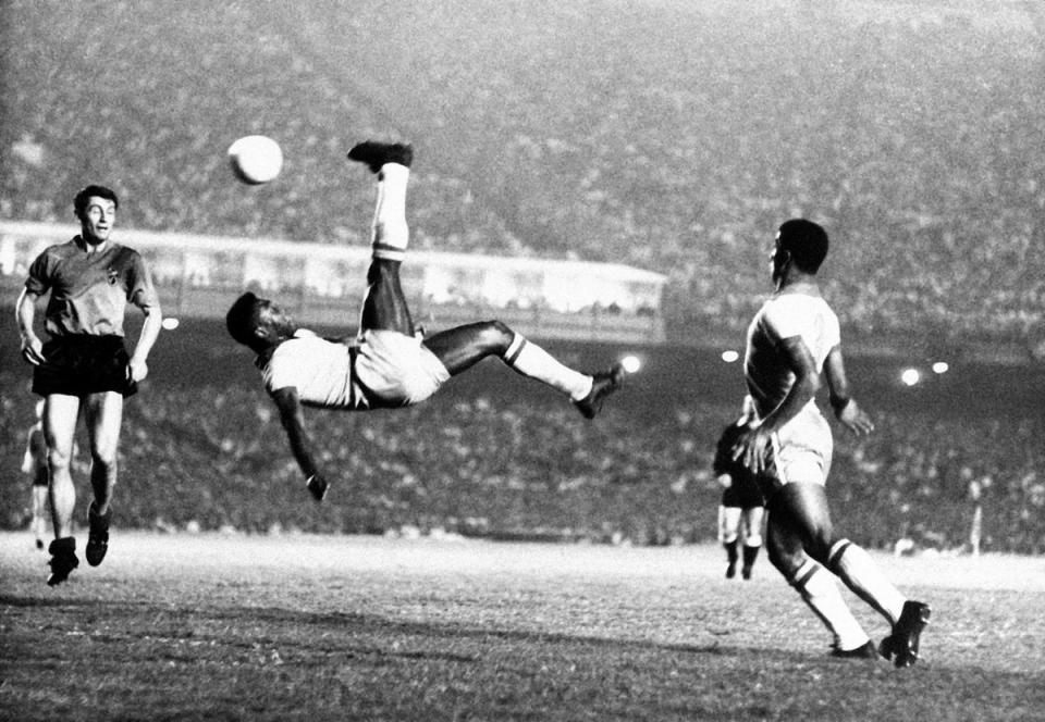 Pele bicycle kicks a ball during a game at unknown location, September 1968. (AP)