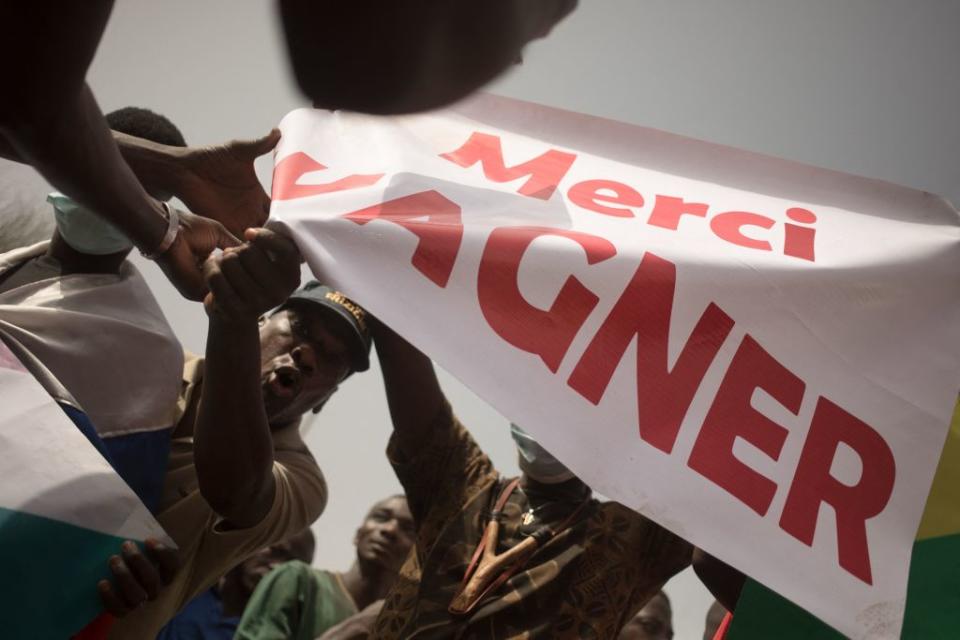 Protesters hold a banner reading "Thank you Wagner," the name of the Russian private security firm in Mali, during a celebration of the French military withdrawal, Bamako, Feb. 19, 2022.<span class="copyright">FLORENT VERGNES/AFP via Getty Images</span>