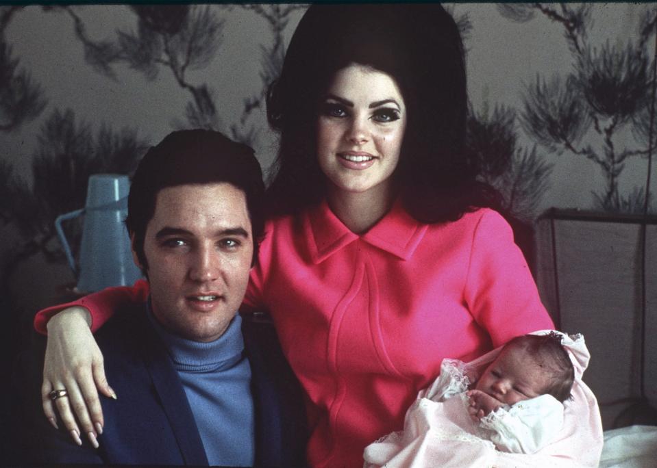Elvis Presley poses with wife Priscilla and daughter Lisa Marie, in a room at Baptist hospital in Memphis, Tenn., on Feb. 5, 1968. | Associated Press