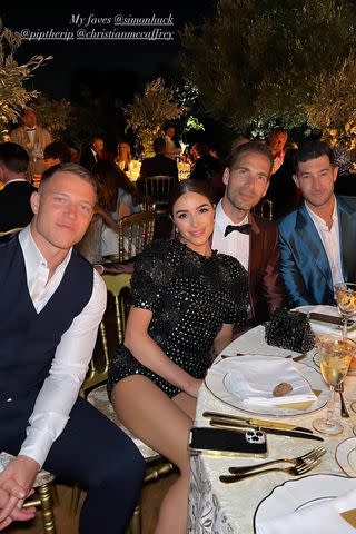 <p>Olivia Culpo/Instagram</p> Olivia Culpo and Christian McCaffrey pose alongside Simon Huck and husband Phil Riportella