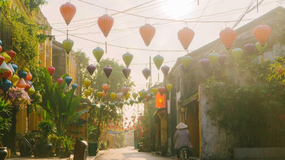 Woman walking in Hoi An in the morning