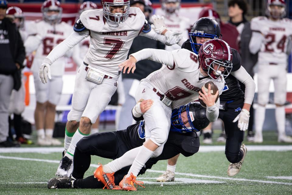 West Boylston's Jake O'Brien hauls down Carver's Jameson Helms in the Division 8 Super Bowl at Gillette Stadium.