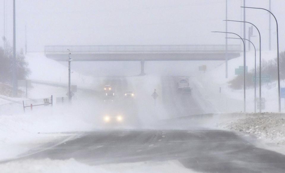 Visibility on I-94 in the Bismarck, N.D., Mandan area is greatly reduced due to blowing snow across the roadway in this view of westbound traffic on the Grant Marsh Bridge over the Missouri River on Thursday, Dec. 15, 2022. (Tom Stromme/The Bismarck Tribune via AP)