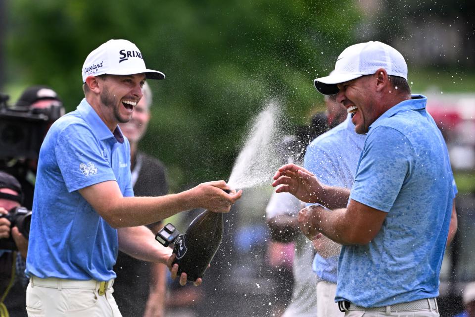 Aug 18, 2024; Greenbrier, West Virginia, USA; Smash GC John Catlin sprays winner Brooks Koepka on the 18th greeen at The Old White at the Greenbrier. Mandatory Credit: Bob Donnan-USA TODAY Sports