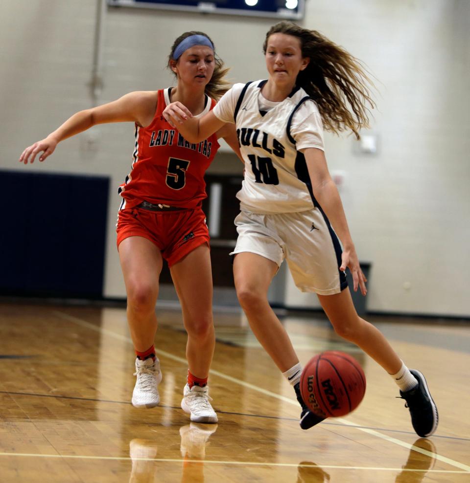 Mary Portwood of Parrish Community High drives to the basket against Abigail Matheny of Lemon Bay High during Friday''s game in Parrish