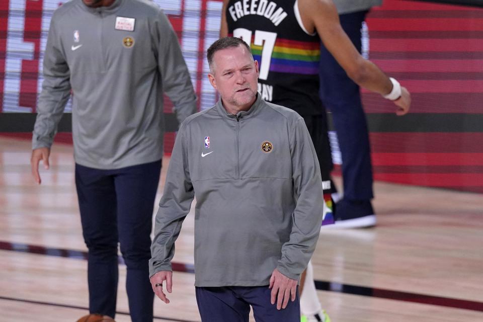 Denver Nuggets head coach Michael Malone walks onto the court during a time out in the second half of Game 3 of the NBA basketball Western Conference final against the Los Angeles Lakers on Tuesday, Sept. 22, 2020, in Lake Buena Vista, Fla. (AP Photo/Mark J. Terrill)