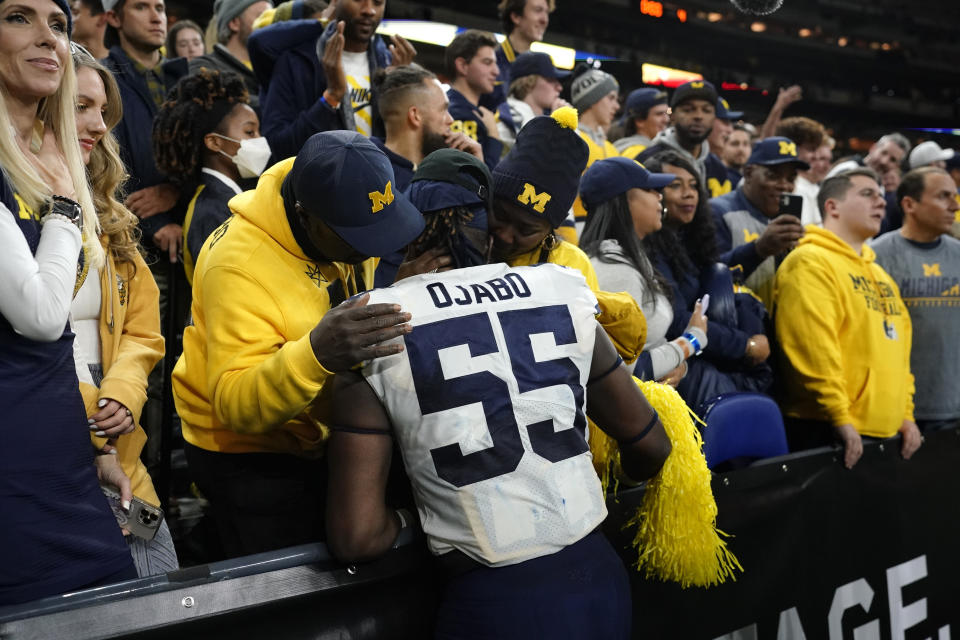 Michigan linebacker David Ojabo (55) celebrates with fans after the Big Ten championship NCAA college football game against Iowa, Sunday, Dec. 5, 2021, in Indianapolis. Michigan won 42-3. (AP Photo/AJ Mast)