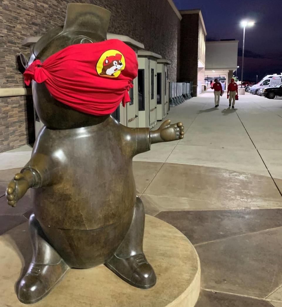 A statue of the famous Buc-ee’s beaver mascot sports a face mask last fall in Terrell, Texas. Now that Texas has lifted COVID restrictions, individual companies must decide whether to require employees or customers to wear masks. Buc-ee’s locations still have signs at entrances stating that masks are required, although some patrons ignore the postings.