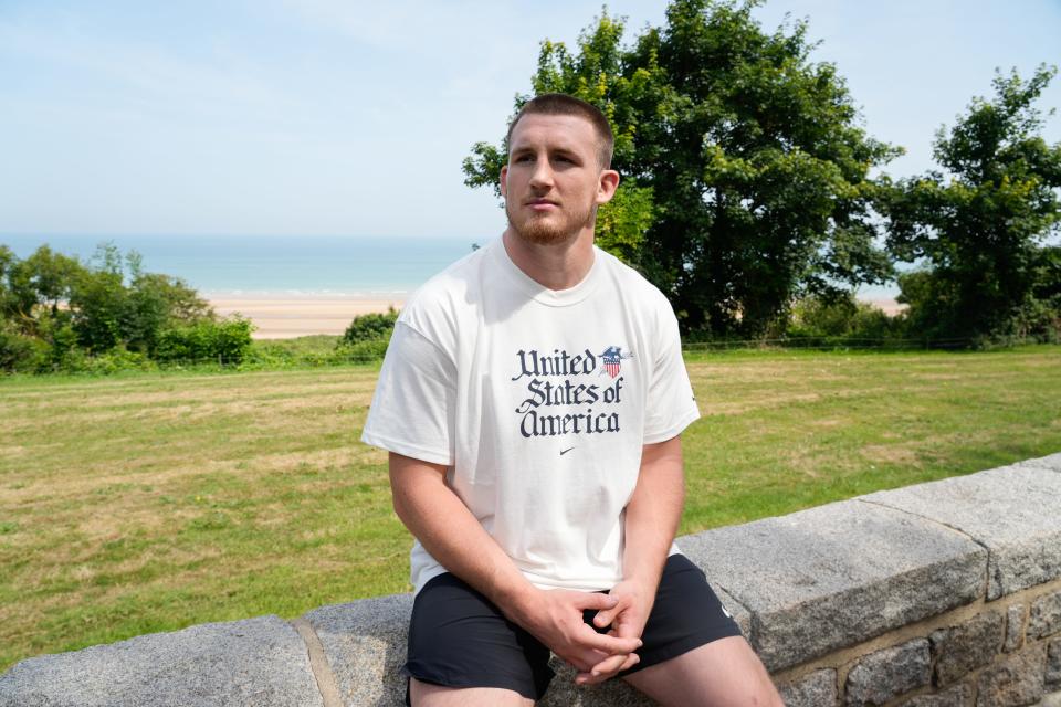 U.S. Olympic wrestler Mason Parris poses for a portrait at the Normandy American Cemetery in Normandy, France. Eighty years ago, on June 6, 1944, Parris' great-grandfather, Vemont Marqua, was part of the D-Day invasion of Normandy, when more than 150,000 Allied troops landed at five beachheads in northern France to start the end of World War II.