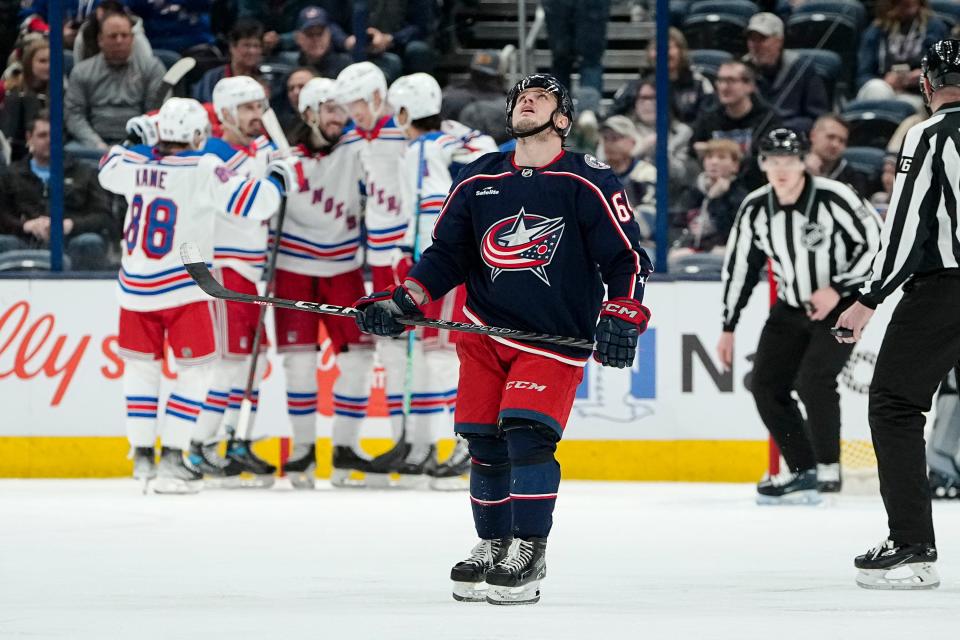 Columbus Blue Jackets right wing Trey Fix-Wolansky (64) reacts to a goal by New York Rangers defenseman Niko Mikkola (77) during the third period of the NHL hockey game at Nationwide Arena on April 8, 2023. The Blue Jackets lost 4-0.
