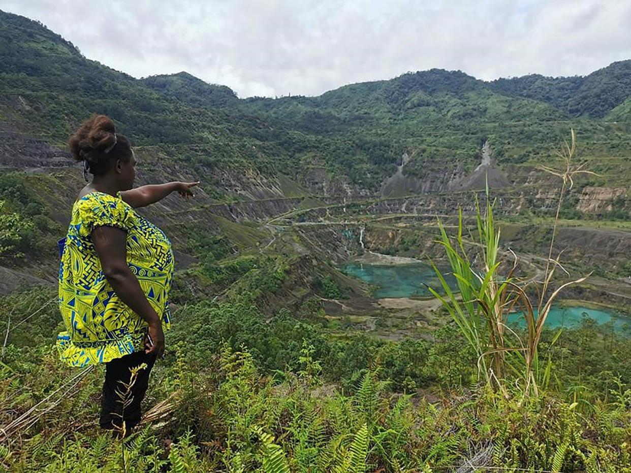 Local resident and advocacy group member Theonila Roka Matbob standing in front of the abandoned Panguna mine pit in Bougainville (AFP via Getty Images)