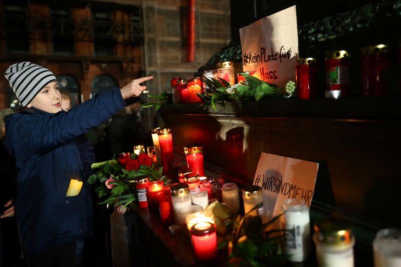 People attend a vigil for the victims of a shooting in Hanau