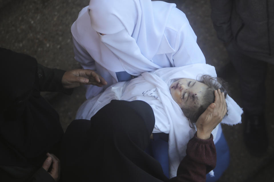 Palestinians mourn a child killed in the Israeli bombardment of the Gaza Strip outside a morgue in Khan Younis on Sunday, Jan. 7, 2024. (AP Photo/Mohammed Dahman)