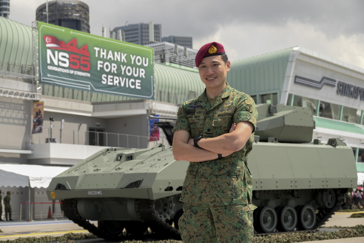 Singapore Armed Forces' Chief of Army David Neo stands besides a tank display at the Army Open House 2022 at the F1 Pit Building.
