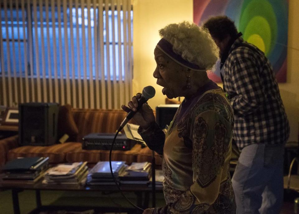 Betty Douglas singing at a home rehearsal.