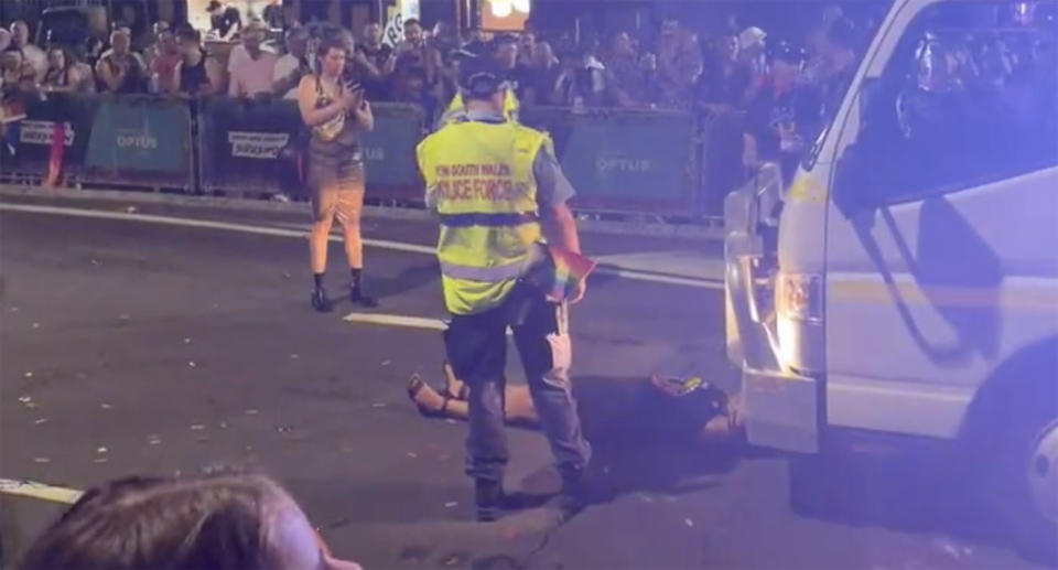 Senator Lidia Thorpe lies down in the middle of the road, bringing the Mardi Gras parade to a halt.