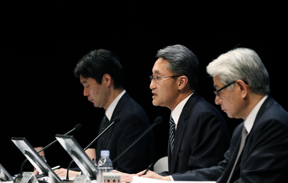 Sony Corp. President and CEO Kazuo Hirai, center, speaks during a press conference at the Sony headquarters in Tokyo Thursday, Feb. 6, 2014. Sony is in talks to sell its troubled personal computer business and Thursday lowered its earnings forecast for the business year ending March to a 110 billion yen loss ($1.1 million).The company also said it's cutting its global workforce by about 3 percent or 5,000 people by the end of March 2015 as it restructures its PC, television and other businesses. (AP Photo/Shizuo Kambayashi)