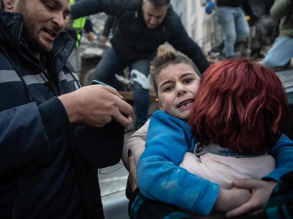 Yigit Cakmak, 8-years-old survivor at the site of a collapsed building, hugs his mother, after workers rescued him 52 hours after the earthquake struck, on February 08, 2023 in Hatay, Turkey.