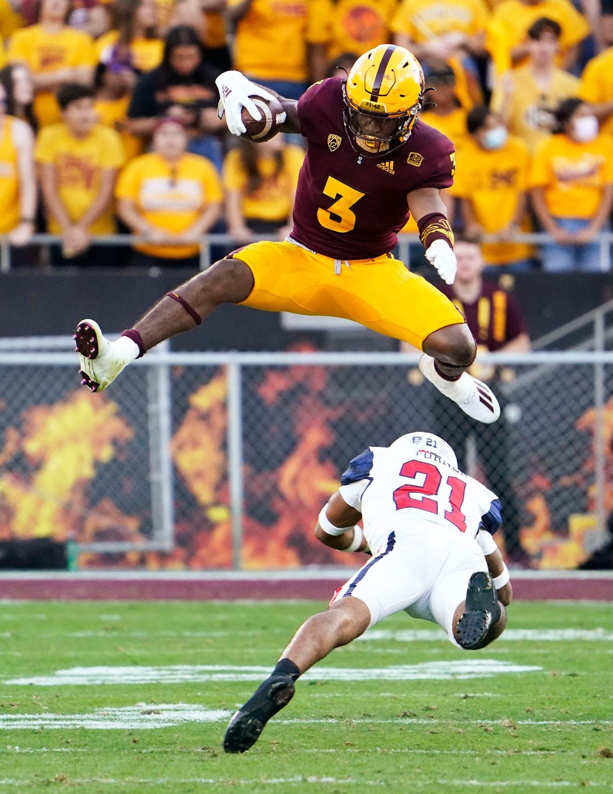 Arizona State Sun Devils running back Rachaad White (3) jumps over Arizona Wildcats safety Jaxen Turner (21) during the 95th Territorial Cup game at Sun Devil Stadium in Tempe, Arziona, on Nov. 27, 2021.
