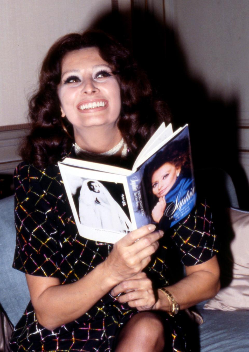 <span><span>Sophia with her book, 1980</span><span>Armando Pietrangeli/Shutterstock</span></span>