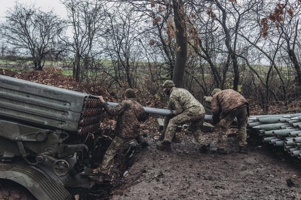 Ukrainian soldiers reload a Grad multiple-launch rocket system