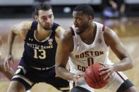 Boston College's Frederick Scott (0) drives past Notre Dame's Nikola Djogo (13) during the second half of an NCAA college basketball game, Saturday, Feb. 27, 2021, in Boston. (AP Photo/Michael Dwyer)