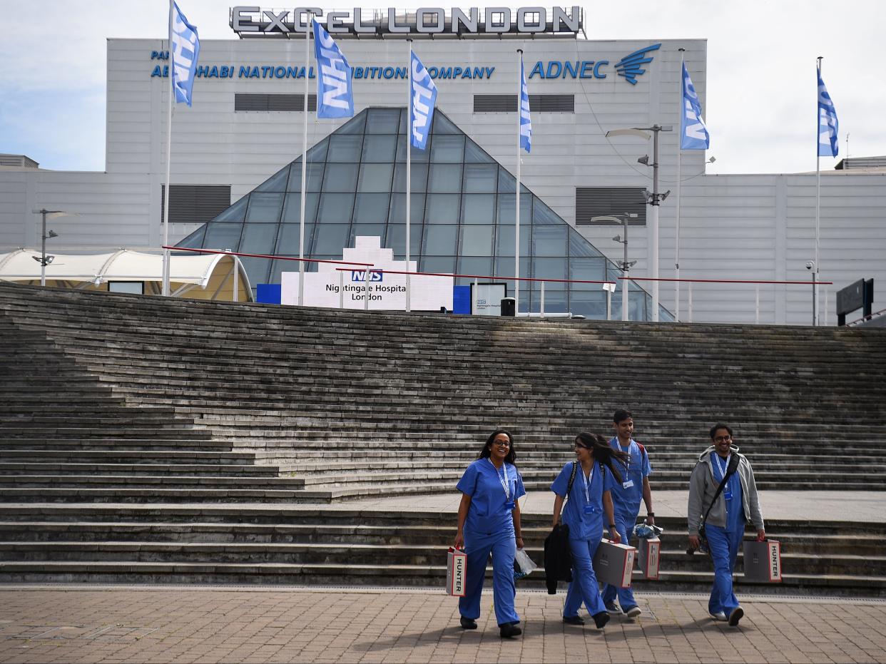 <p>NHS workers leave London’s Nightingale Hospital at the ExCel centre in London</p> (PA)