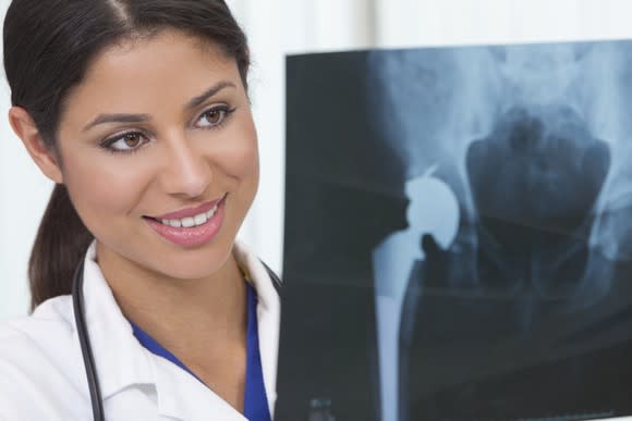 Female Doctor Examining X Ray Of Patient Getty