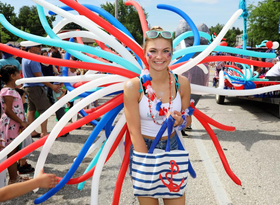 Destiny Bos of Urbandale hands out candy to the kids during the Urbandale Fourth of July parade along 70th street on Thursday, July 4, 2019, in Urbandale.  The parade theme for 2019 is “Celebrating Red, White, and U.”