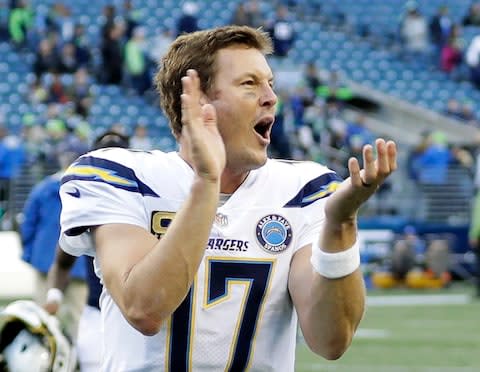 Los Angeles Chargers quarterback Philip Rivers celebrates as he leaves the field after an NFL football game against the Seattle Seahawks - Credit: AP Photo/Ted S. Warren
