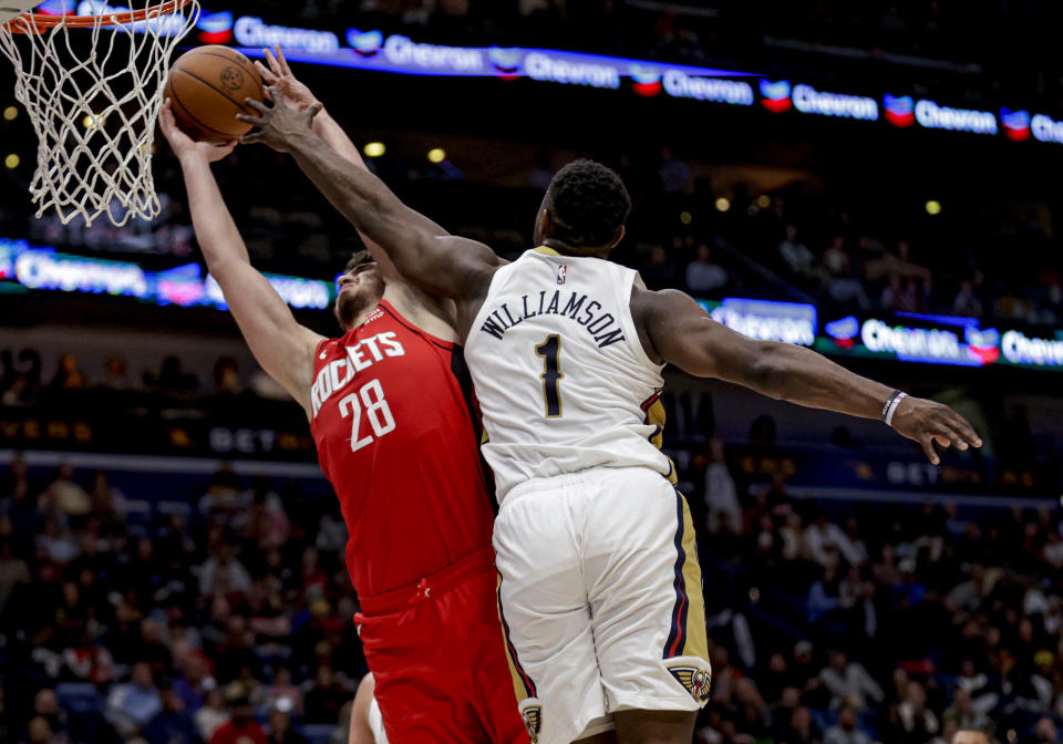 Houston Rockets center Alperen Sengun (28) is defended by New Orleans Pelicans forward Zion Williamson (1) during the first half of an NBA basketball game in New Orleans, Thursday, Feb. 22, 2024. (AP Photo/Derick Hingle)