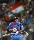 FILE - In this April 2, 2011, file photo, Indian cricket captain Mahendra Singh Dhoni, facing camera, and Yuvraj Singh, celebrate after winning the Cricket World Cup final match against Sri Lanka in Mumbai, India. India great Dhoni announced his retirement from international cricket on Saturday, Aug. 15, 2020. Under Dhoni’s stewardship, India won the T20 World Cup in 2007, the 50-over World Cup in 2011 and the Champions Trophy in 2013. (AP Photo/Gurinder Osan, File)