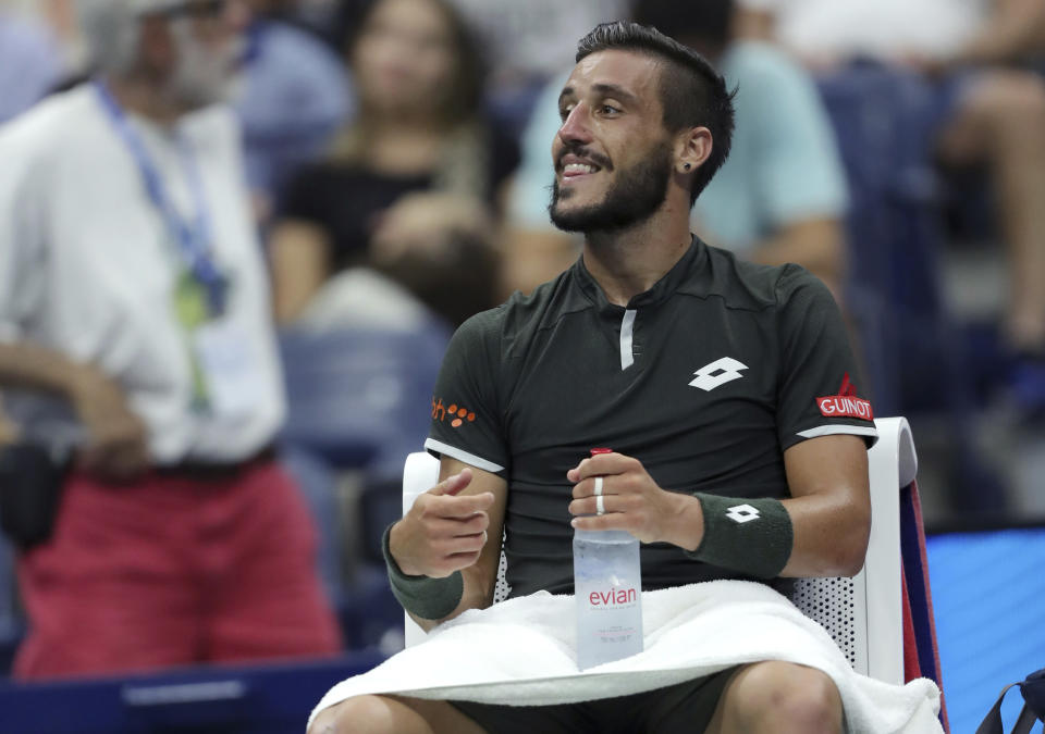 Damir Dzumhur, of Bosnia, reacts to his corner during a break in his second round match of the US Open tennis championships against Roger Federer, of Switzerland, Wednesday, Aug. 28, 2019, in New York. (AP Photo/Eduardo Munoz Alvarez)