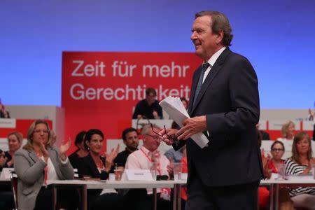 Former German Chancellor Gerhard Schroeder leaves the stage at the Social Democratic party (SPD) convention in Dortmund, Germany, June 25, 2017. REUTERS/Wolfgang Rattay